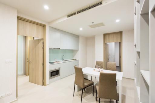 Modern kitchen with adjacent dining area in a bright apartment