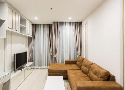 Modern living room with a comfortable brown sofa and flat-screen TV