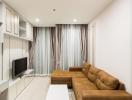 Modern living room with a comfortable brown sofa and flat-screen TV