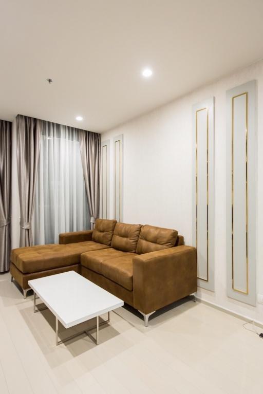 Modern living room interior with leather sofa and white coffee table