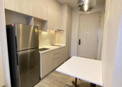 Modern kitchen with stainless steel appliances and wooden flooring