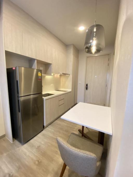 Modern kitchen with stainless steel appliances and wooden flooring