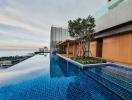 Luxurious rooftop infinity pool overlooking the city with patio area
