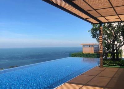 Luxury outdoor swimming pool with ocean view and wooden deck