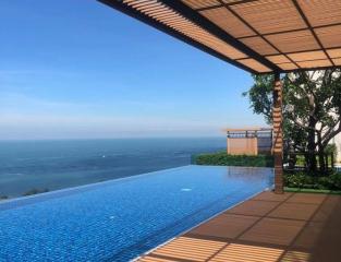 Luxury outdoor swimming pool with ocean view and wooden deck