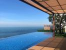 Luxury outdoor swimming pool with ocean view and wooden deck