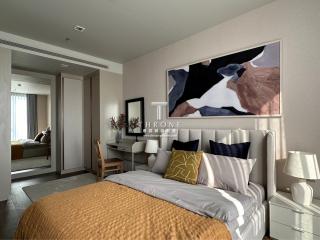 Cozy modern bedroom with large wall art and warm colors