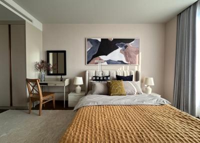 Elegantly decorated bedroom with a large bed and artwork