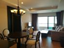 Spacious living room with natural lighting, dining area, and balcony access