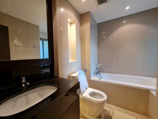 Modern bathroom interior with a wide mirror and tile finish