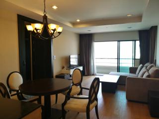 Spacious living room with dining area and balcony access