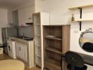 Compact kitchen with modern appliances and wooden shelving