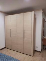 Spacious bedroom with a large wooden wardrobe