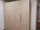 Spacious bedroom with a large wooden wardrobe