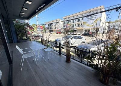 Spacious balcony with outdoor seating and a street view