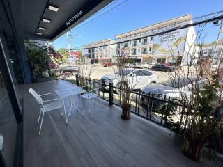 Spacious balcony with outdoor seating and a street view