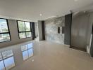 Spacious and bright unfurnished living room with large windows and polished tile flooring