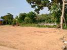 Empty plot of land ready for construction with surrounding greenery