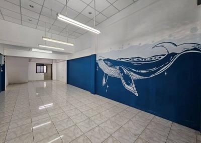 Spacious interior with artistic whale mural on blue wall