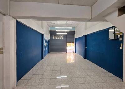 Spacious tiled entrance hallway with blue walls in a building