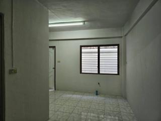 Sparse unfurnished room with tiled floor and window