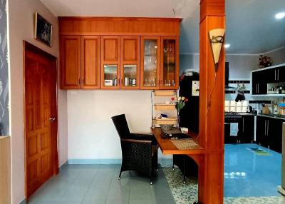 Spacious interior with wooden cabinetry and kitchen area
