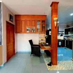 Spacious interior with wooden cabinetry and kitchen area