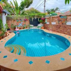 Inviting outdoor swimming pool with surrounding garden and sitting area in a residential property