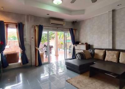 Spacious living room with modern furnishings and natural lighting