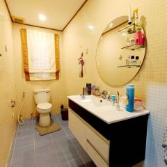 Spacious modern bathroom with white fixtures and beige wall tiles