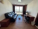 Cozy living room with leather sofa, wooden flooring, and a scenic window