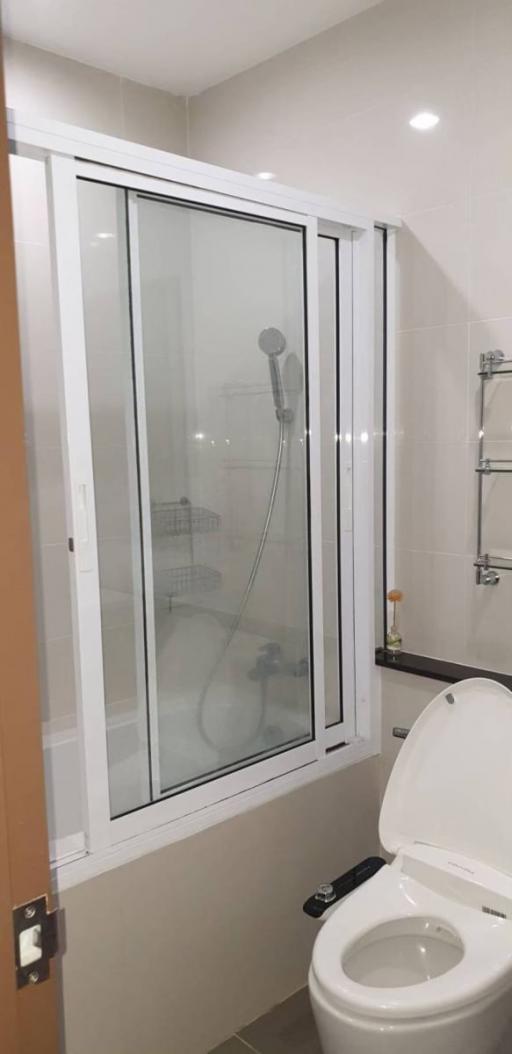 Modern bathroom with glass shower and white toilet