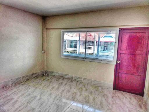 Spacious empty room with tiled flooring and large window