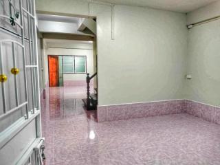 Empty interior space with pink tiled flooring and white walls