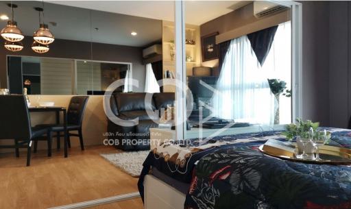 Modern Bedroom with Reflective Glass Door and Open Plan Living Area Design