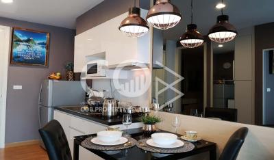 Modern kitchen with dining area, stylish pendant lights, and a welcoming ambiance