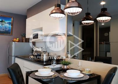Modern kitchen with dining area, stylish pendant lights, and a welcoming ambiance