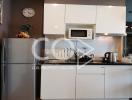 Modern kitchen with stainless steel appliances and white cabinets