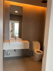 Modern bathroom with large mirror and city view