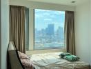 Bright bedroom with large window offering city view