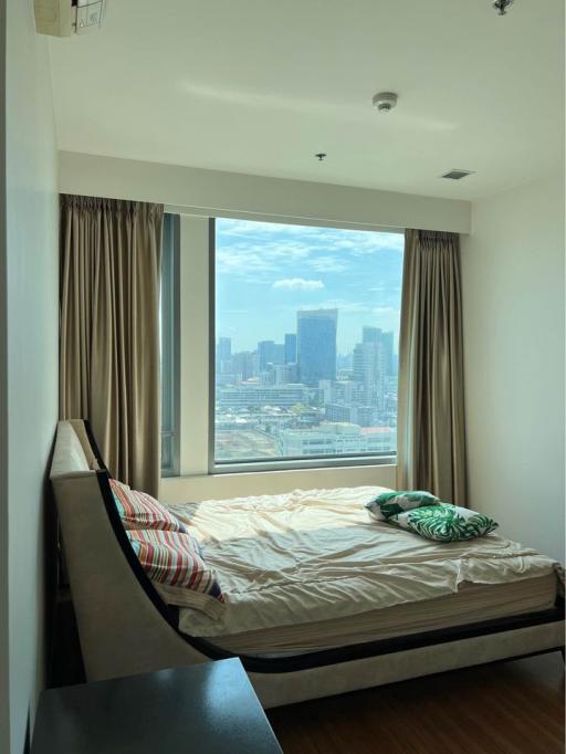 Bright bedroom with large window offering city view