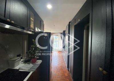 Modern kitchen with black cabinets and wood flooring