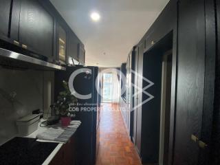 Modern kitchen with black cabinets and wood flooring