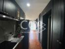 Modern kitchen with black cabinets and wood flooring