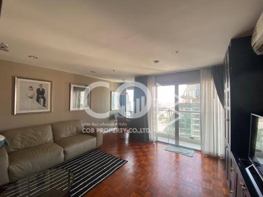 Spacious living room with natural light and modern furnishings