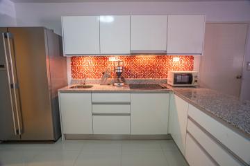 Modern kitchen with stainless steel appliances and mosaic backsplash