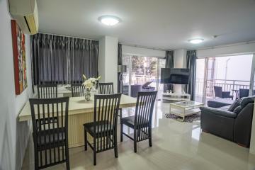 Spacious living room with dining area and balcony access