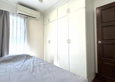 Spacious bedroom with a large bed and built-in wardrobes