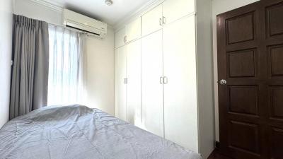 Spacious bedroom with a large bed and built-in wardrobes