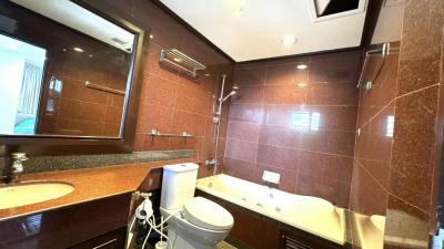 Modern bathroom interior with granite countertop and large mirror